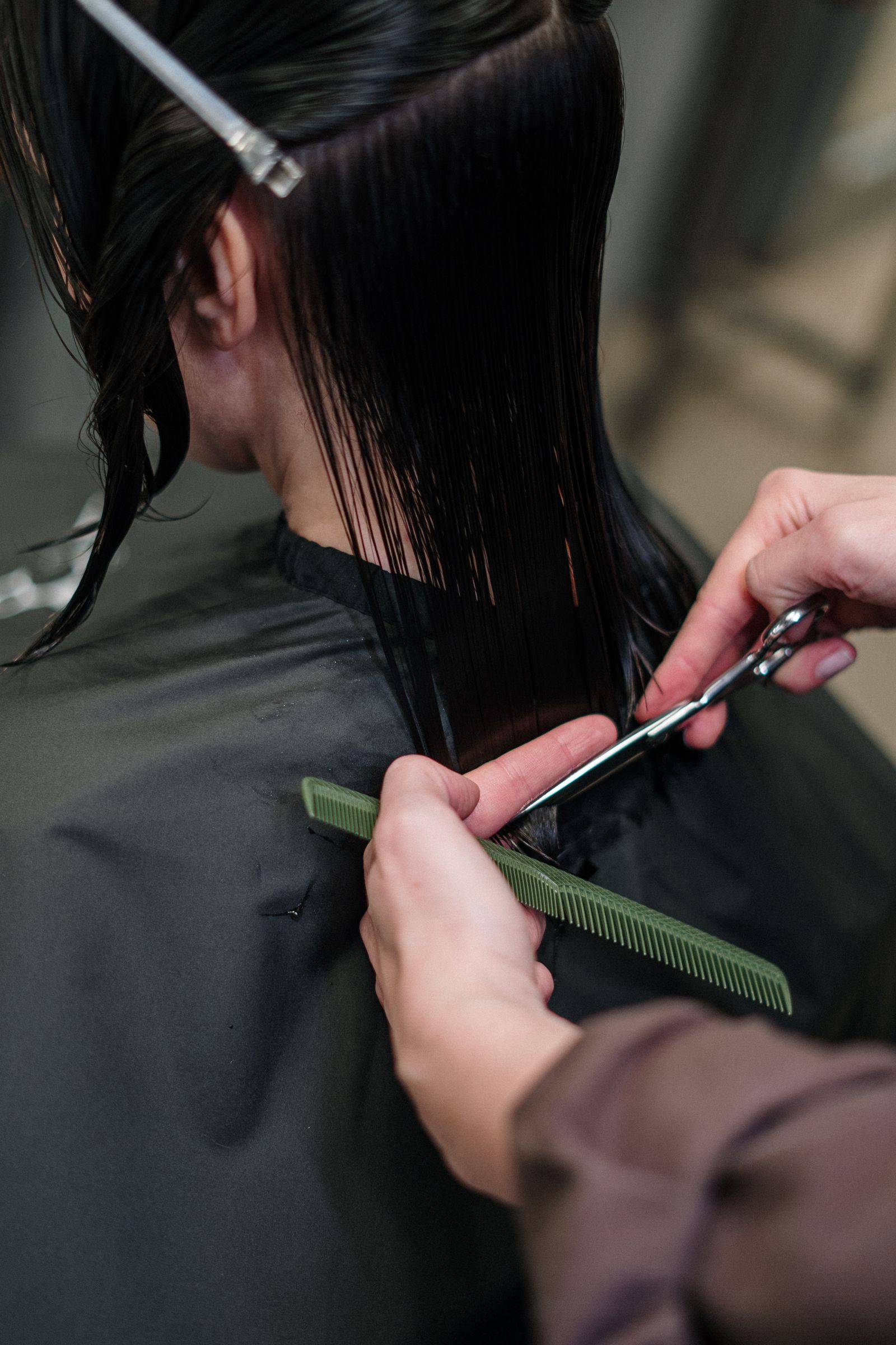 A stylist making a precise haircut